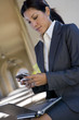 Businesswoman checking text messages outdoors