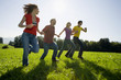 Friends holding hands and running.