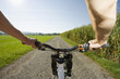 A close-up of a man's hands on the bicycle.