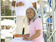Senior woman on boat drinking white wine