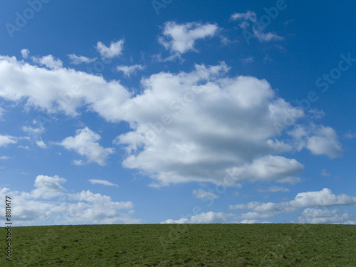 Photo: Blue sky, clouds and green field Blue sky, clouds and green field
