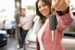 Woman holding up new car keys