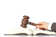 Holding a wooden gavel over the law book Holding a wooden gavel over the law book