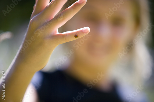 Photo: Girl (8-10) with ladybird on finger, close-up of hand Girl (8-10) with ladybird on finger, close-up of hand