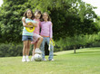 Photo: Three girls (7-9) standing on grass in park with frisbee, soccer ball and skipping rope, portrait Three girls (7-9) standing on grass in park with frisbee, soccer ball and skipping rope, portrait