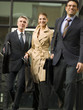 Three business people leaving office.