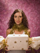 Woman wearing Christmas garland and holding a present.