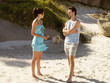A couple talking on the beach.