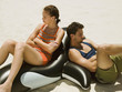 Couple sitting on an inflatable orca