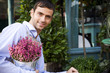 Male florist arranging the plant display outside his shop