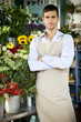 Male florist standing amongst the flowers in his shop
