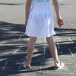 Young girl playing hopscotch, close-up
