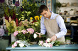 Male florist creating a bouquet of flowers