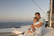 A couple relaxing with a drink on a boat