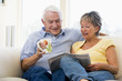 Couple reading newspaper with coffee smiling Couple reading newspaper with coffee smiling