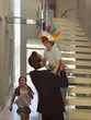 Father carrying his son, daughter running towards him.