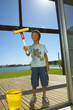 A boy cleaning the glass door.