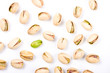 Pistachio nuts and one naked core isolated on white