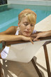 Woman sitting by the pool.