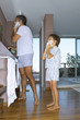 Father and son shaving in the bathroom.