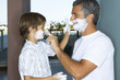 Father and son applying shaving foam.