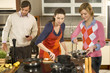 People cooking in the kitchen.