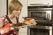 Woman smelling freshly baked muffins.