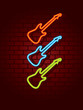 Neon guitars on brick wall