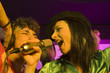 Photo: Close-up of a young couple singing in a nightclub Close-up of a young couple singing in a nightclub