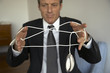 Mature man tangled in a computer mouse wire