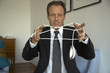 Mature man tangled in a computer mouse wire