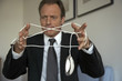 Mature man tangled in a computer mouse wire
