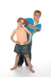 brother and sister standing on a high key background brother and sister standing on a high key background