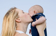 Mother Holding Son Up Kissing Him on Cheek