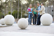 Photo: Teenage school students (16-18) in conversation with male teacher on concrete ball outdoors Teenage school students (16-18) in conversation with male teacher on concrete ball outdoors