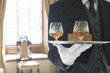 Butler with tray of drinks, mid section