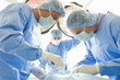 Surgeons operating on patient, low angle view