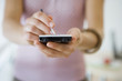 Photo: Woman using personal electronic organiser, mid-section, front view, close-up, focus on foreground Woman using personal electronic organiser, mid-section, front view, close-up, focus on foreground