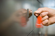 Photo: Woman holding red key ring, turning key in door lock, side view, close-up (blurred motion) Woman holding red key ring, turning key in door lock, side view, close-up (blurred motion)