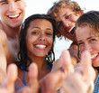 Two young couples smiling at the beach.