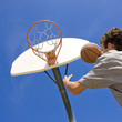 Basketball player jumps for hoop