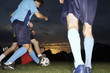 Soccer players playing soccer