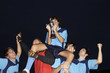 Soccer team cheering with their winning trophy
