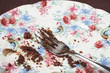 Fork and cake crumbs on plate, close-up