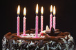 Birthday cake with lit candles, close-up