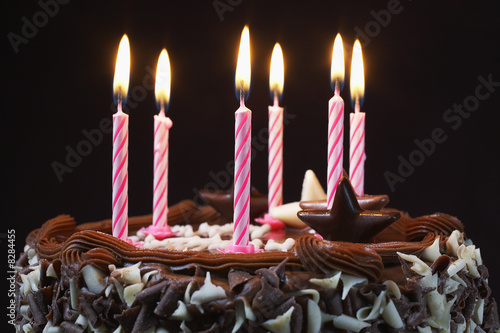 Photo: Birthday cake with lit candles, close-up Birthday cake with lit candles, close-up