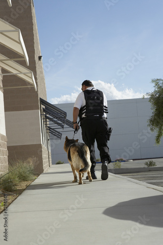 Security guard with dog on patrol