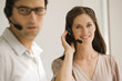 Businessman and a businesswoman wearing headsets