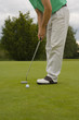 Low section view of a mid adult man playing golf