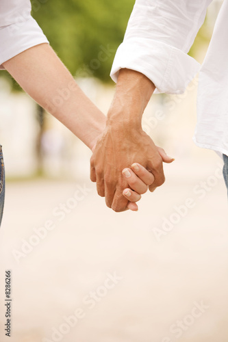 Photo: Close-up of a man and a woman holding each other's hands Close-up of a man and a woman holding each other's hands
